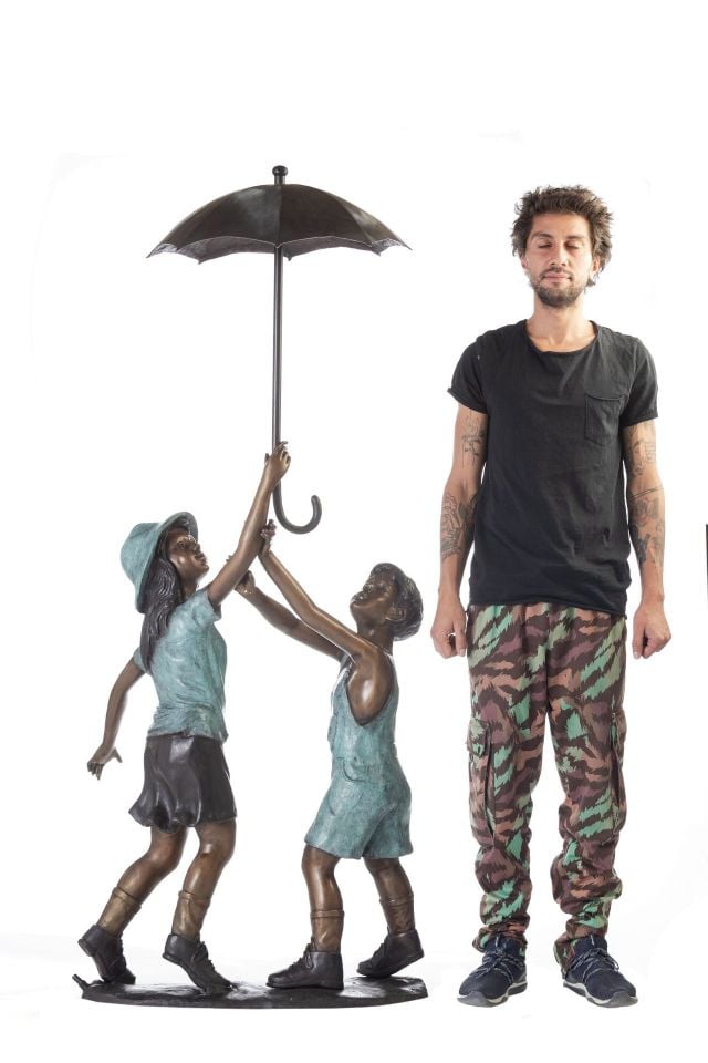 FOUNTAIN OF CHILDREN UNDER AN UMBRELLA