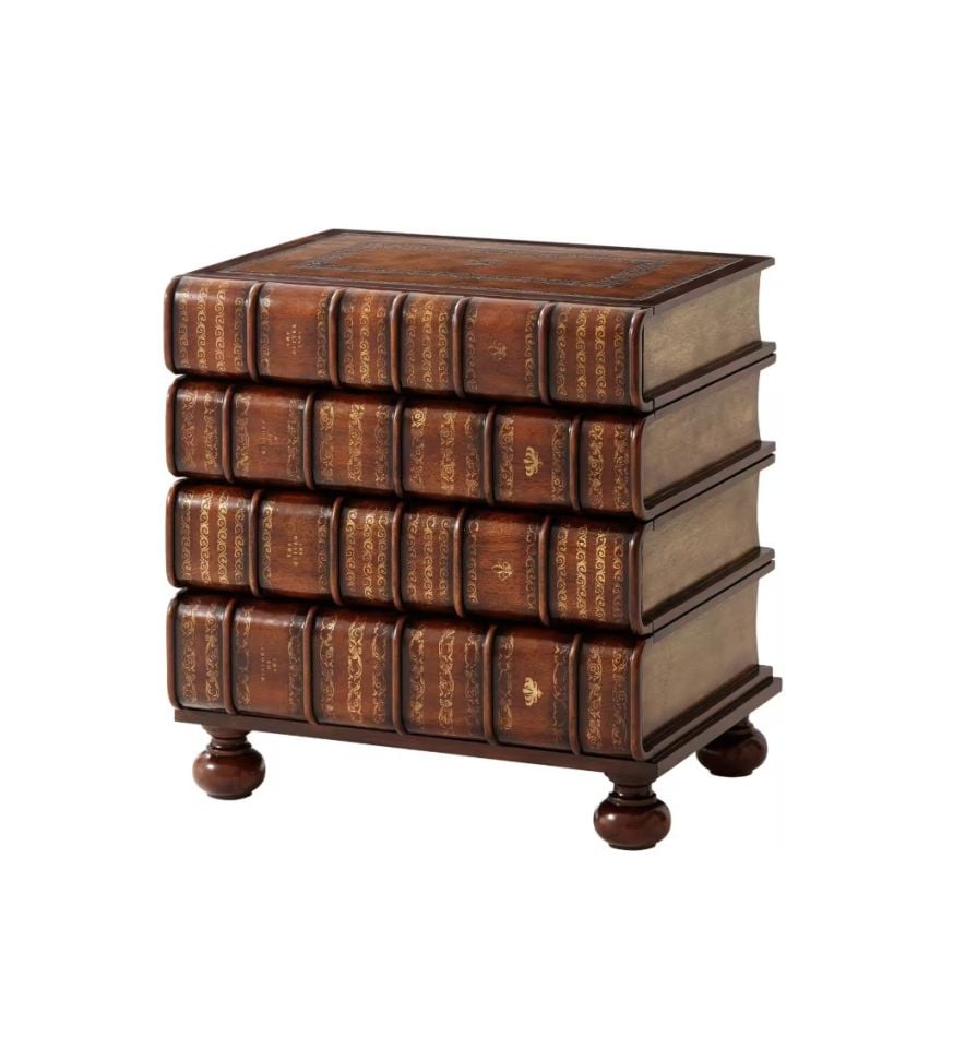 A HAND CARVED AND GILT FAUX BOOK CHEST OF DRAWERS